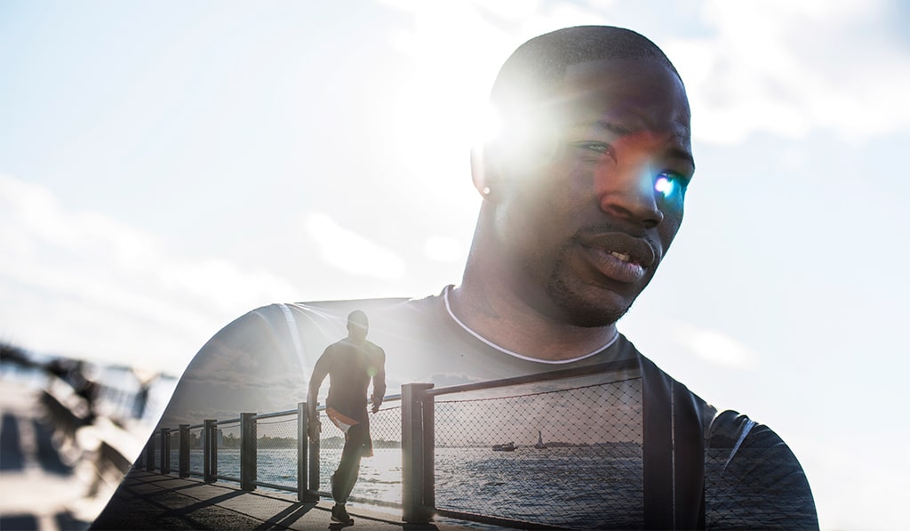 S2 Method Portrait of young man. He is wearing sports clothing. Blue sky in the back. Combined with an image of same man running. Double exposure.